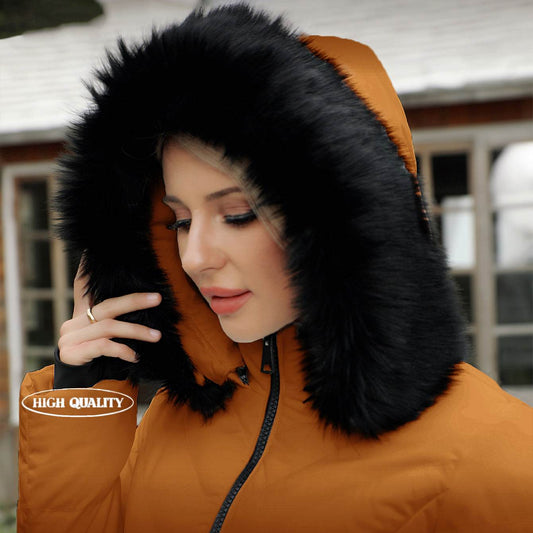 Woman wearing an ELORA puffer coat with faux fur hood, standing outdoors in winter sunlight