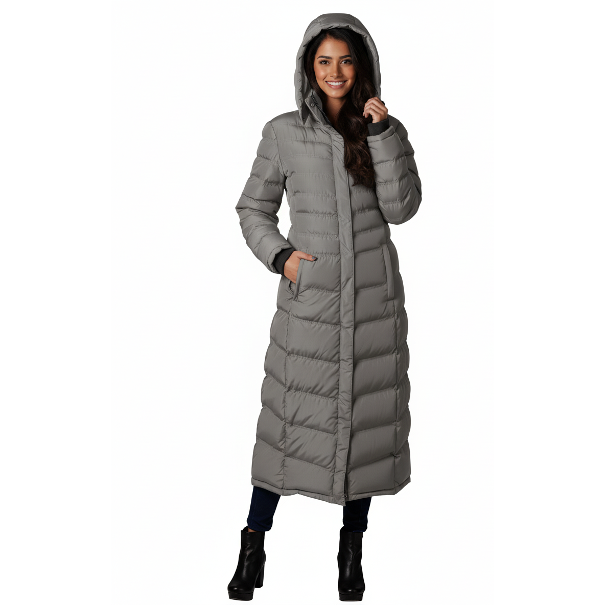Woman wearing a long gray puffer coat on a white background