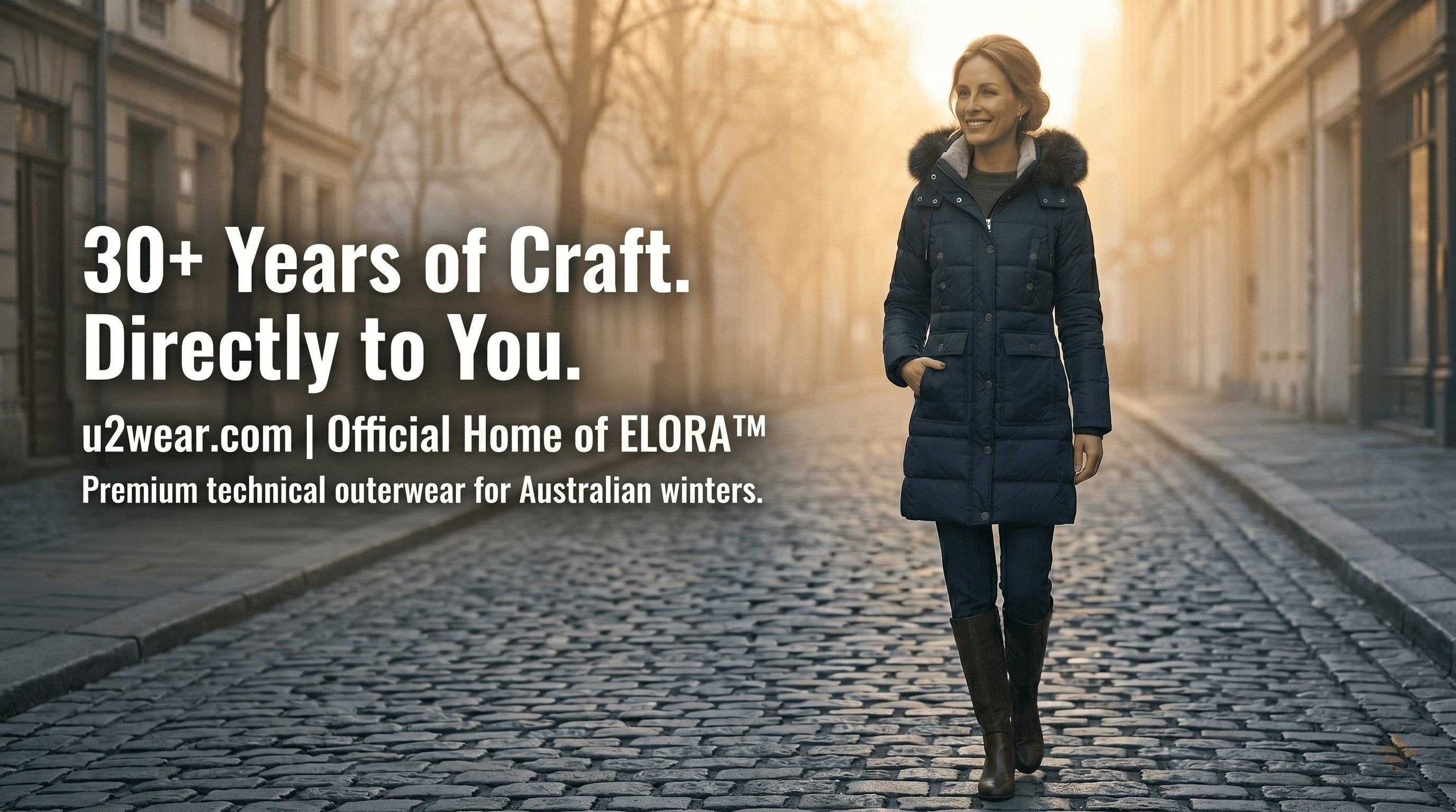 A woman wearing the Navy 2566 ELORA technical parka walking on a misty Melbourne street. Text: 30+ Years of Craft, Directly to You, Official Home of ELORA.