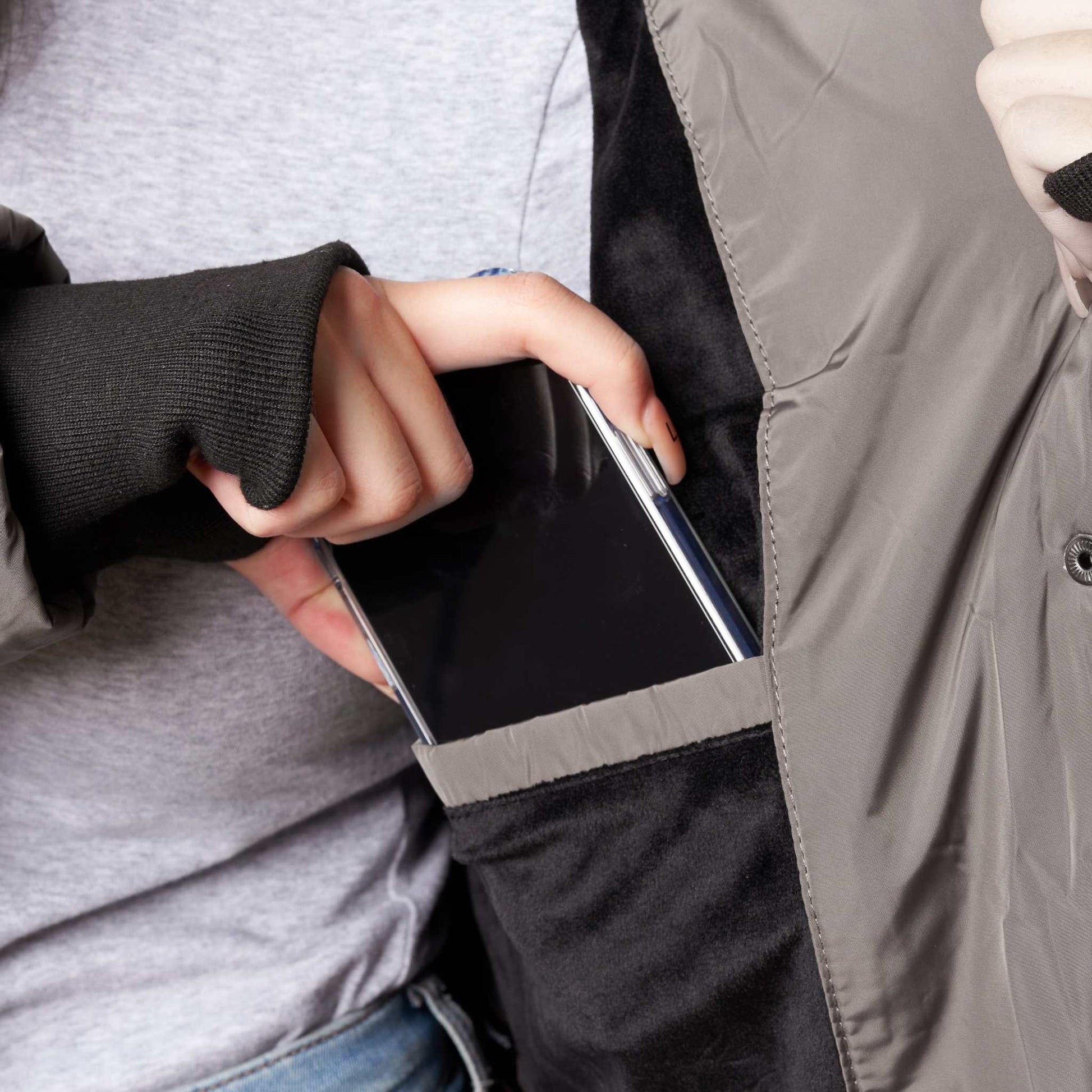 Heavy women's winter coat with thumb holes and phone in pocket.