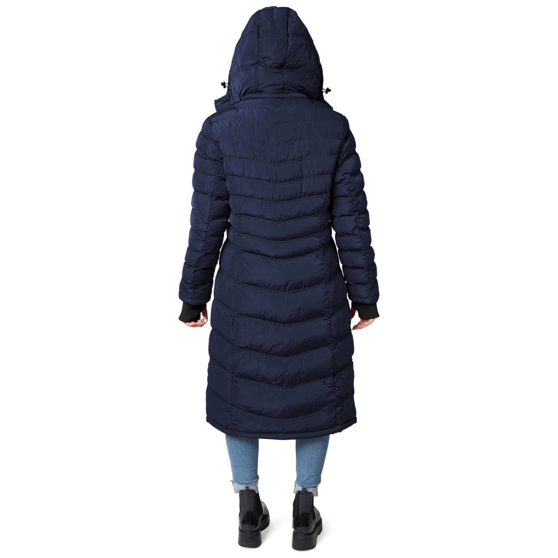 Woman wearing Elora Maxi Puffer vegan winter coat with hood, navy blue, full-length view.