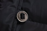 Close-up of the round metal button and fabric attachment on the black ELORA 2566 parka.